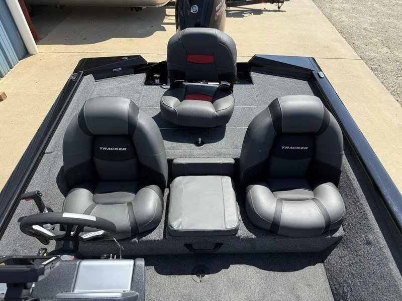 Slide: The Image of 2025 Tracker Pro Team 190 boat interior with three cushioned seats and steering wheel. - 10