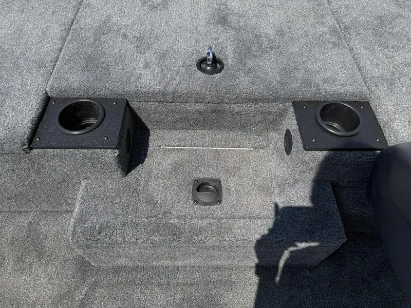 Slide: The Image of 2025 Tracker Pro Team 190 boat interior with carpeted deck and cup holders. - 12