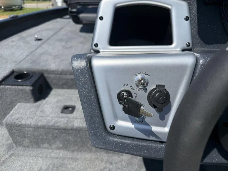 Slide: The Image of 2025 Tracker Pro Team 190 boat dashboard with ignition key and control panel. - 14