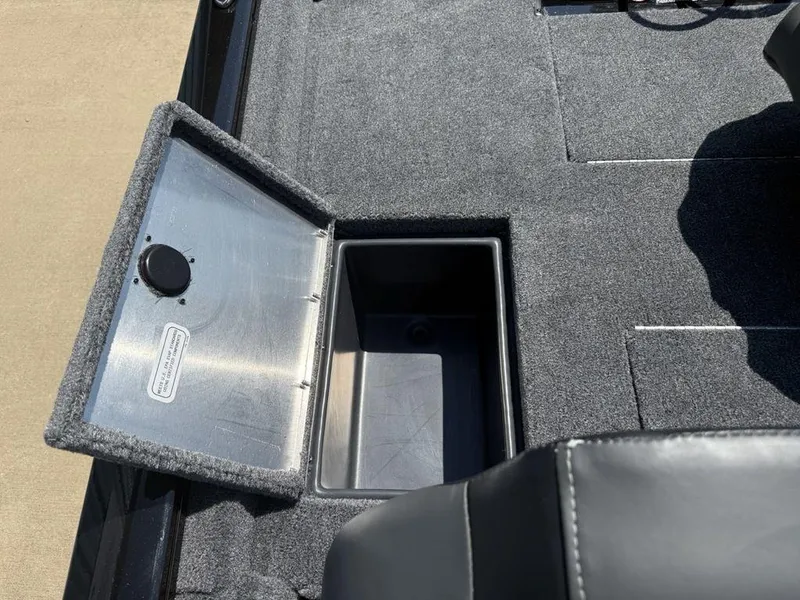 Slide: The Image of Open storage compartment on 2025 Tracker Pro Team 190 boat with carpeted interior. - 17