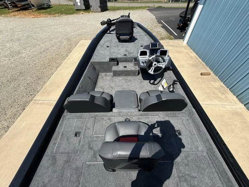 Slide: The Image of 2025 Tracker Pro Team 190 boat interior with gray seating and steering console. - 18