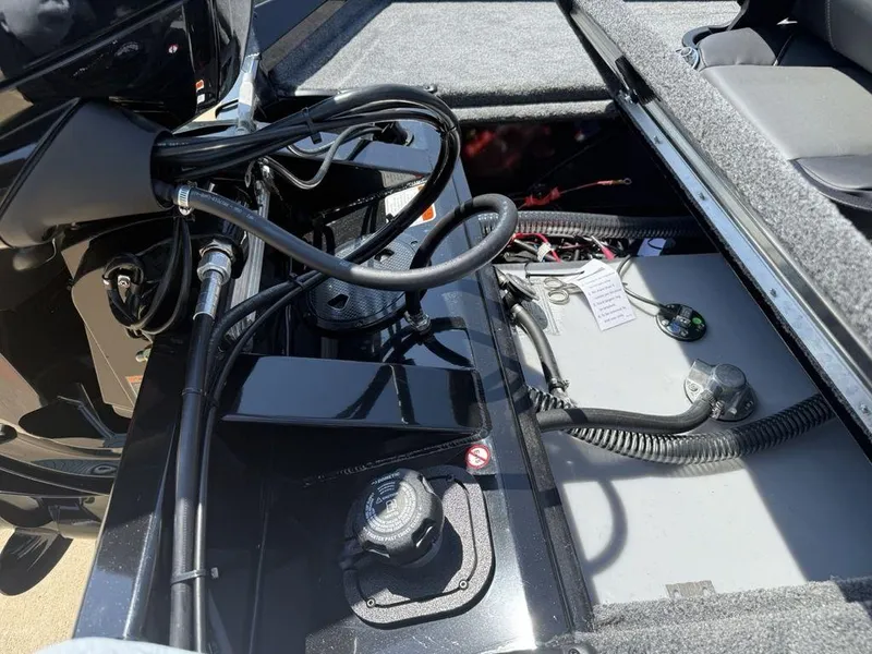 Slide: The Image of 2025 Tracker Pro Team 190 boat interior showing engine and wiring components. - 20