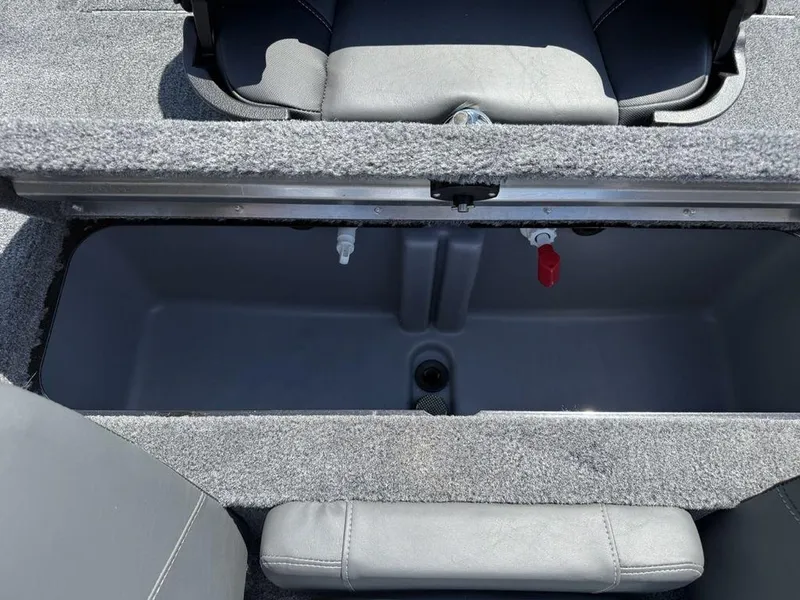 Slide: The Image of Open storage compartment in 2025 Tracker Pro Team 190 boat, featuring gray interior and seating. - 22
