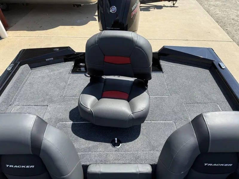 Slide: The Image of 2025 Tracker Pro Team 190 boat interior with cushioned seating and carpeted deck. - 23