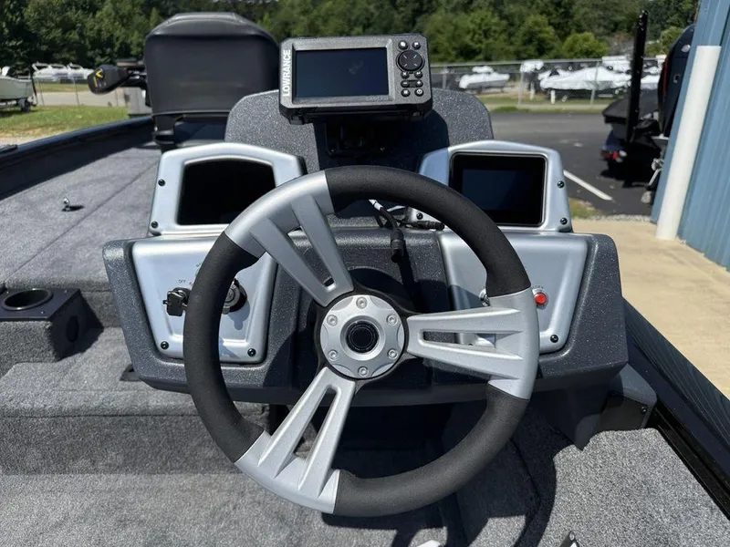 Slide: The Image of 2025 Tracker Pro Team 190 boat dashboard with steering wheel and navigation system. - 7
