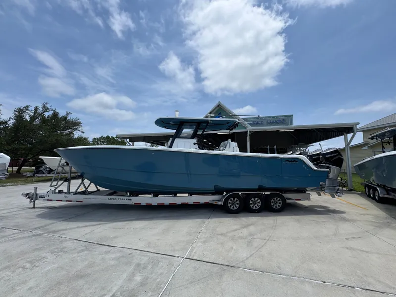 The Image of 2026 Invincible 36 Catamaran on trailer under clear sky at marina. - 1
