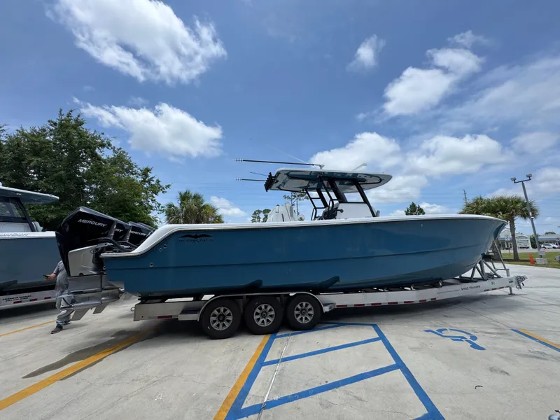 Slide: The Image of 2026 Invincible 36 Catamaran on trailer under blue sky. - 12