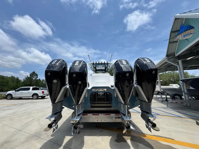 Slide: The Image of 2026 Invincible 36 Catamaran with four powerful outboard engines, parked outdoors. - 15