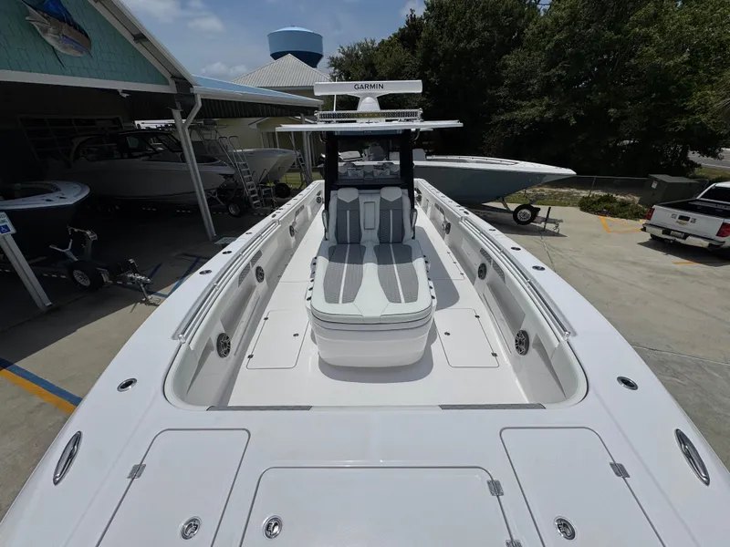 Slide: The Image of 2026 Invincible 36 Catamaran with sleek design, docked at a marina. - 18