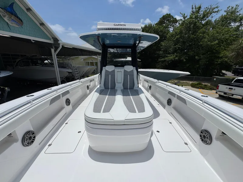 Slide: The Image of 2026 Invincible 36 Catamaran with sleek seating and advanced Garmin navigation system. - 19