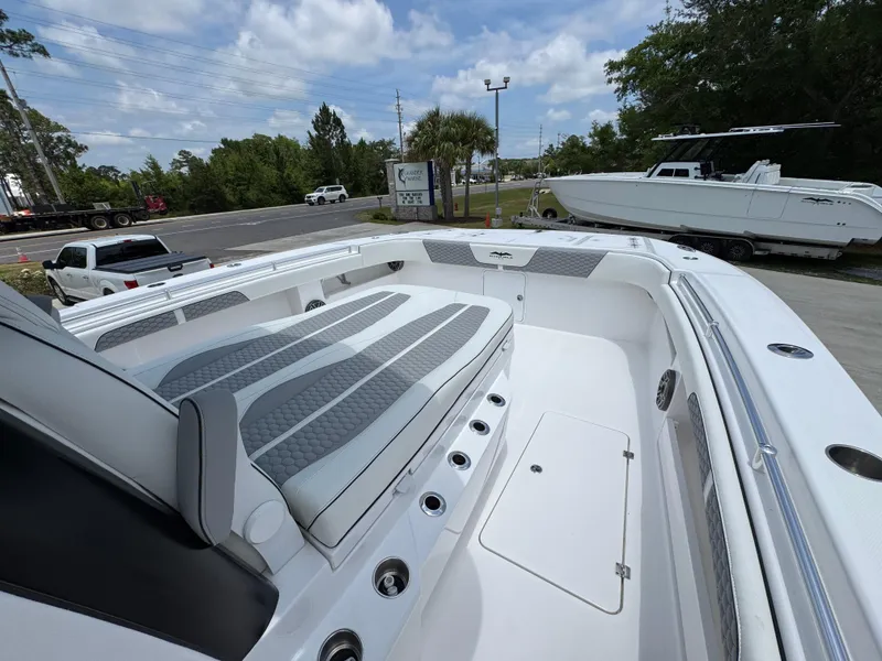 Slide: The Image of 2026 Invincible 36 Catamaran with sleek seating and modern design, parked outdoors. - 20