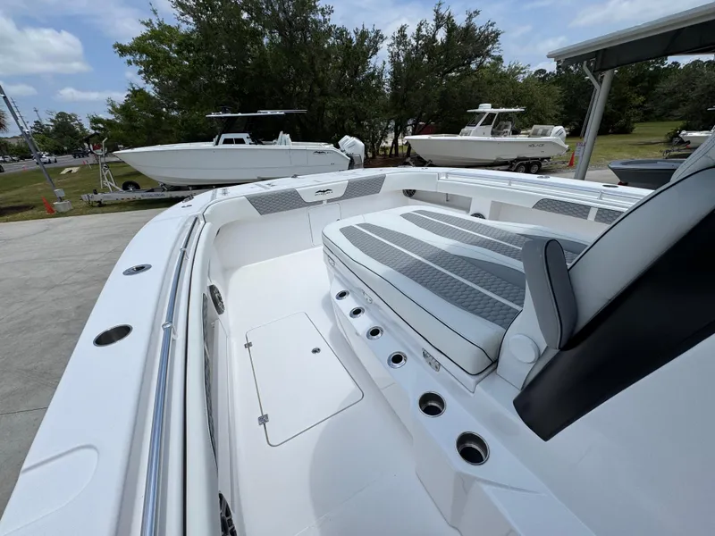 Slide: The Image of 2026 Invincible 36 Catamaran with spacious deck and seating, docked outdoors. - 21