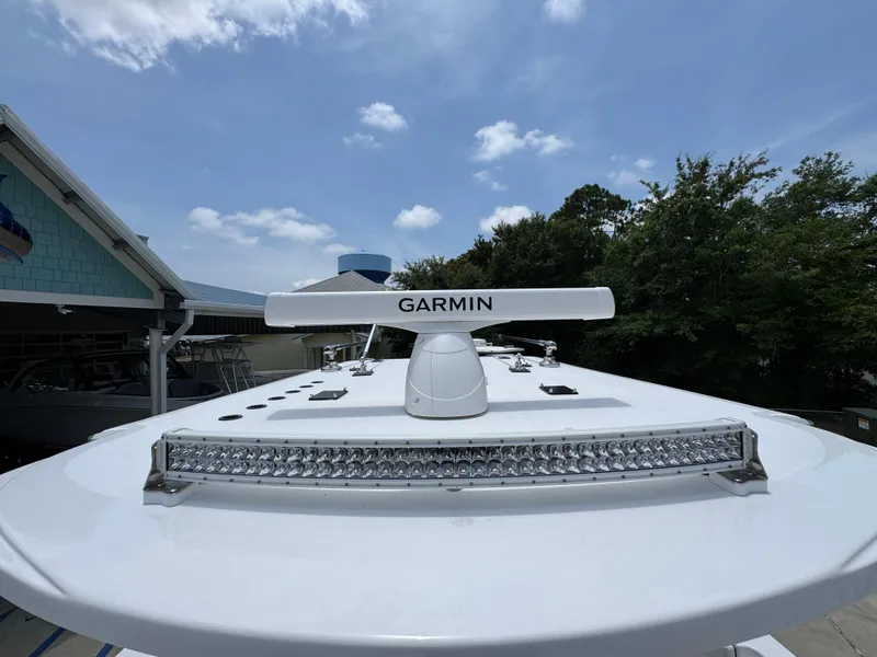 Slide: The Image of 2026 Invincible 36 Catamaran with Garmin radar and LED light bar under a clear sky. - 24