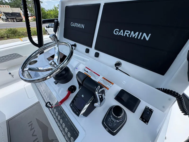 Slide: The Image of Helm of 2026 Invincible 36 Catamaran with dual Garmin displays and modern controls. - 31