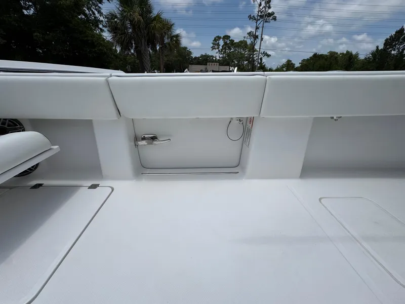 Slide: The Image of 2026 Invincible 36 Catamaran interior with white seating and storage compartments. - 36