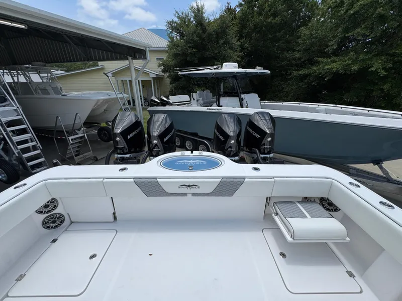 Slide: The Image of 2026 Invincible 36 Catamaran with Mercury engines, docked near other boats. - 37