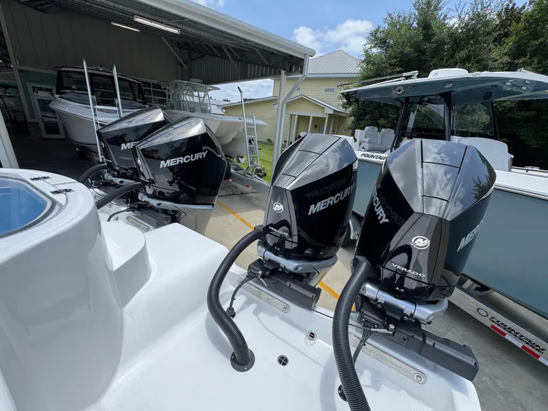 Slide: The Image of 2026 Invincible 36 Catamaran with Mercury outboard engines in a boatyard. - 39