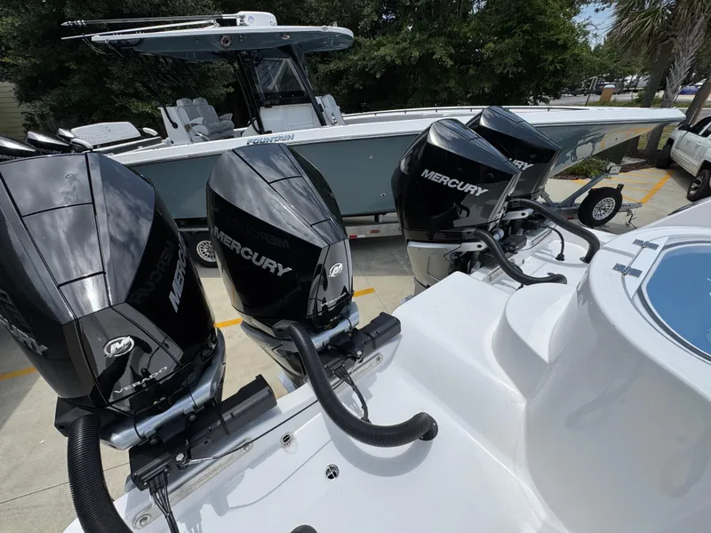 Slide: The Image of 2026 Invincible 36 Catamaran with Mercury outboard engines, parked outdoors. - 40