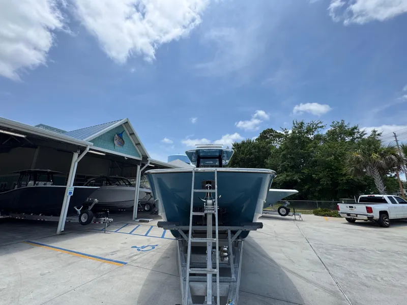 Slide: The Image of 2026 Invincible 36 Catamaran on trailer, parked outdoors under a clear blue sky. - 7