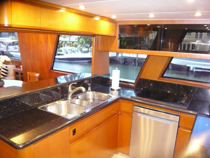Slide: The Image of Luxurious kitchen interior of a 1990 Viking Cockpit Motor Yacht with sleek countertops. - 12