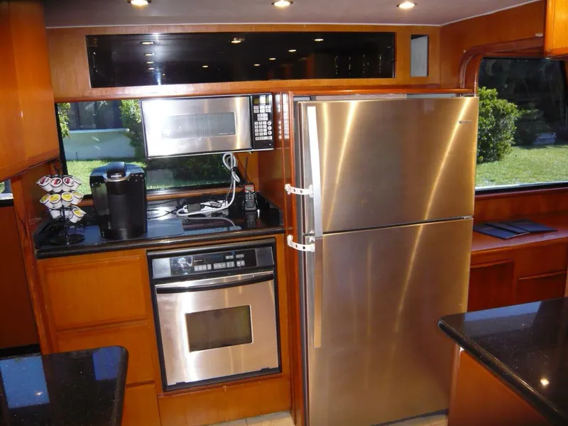 Slide: The Image of Modern kitchen in a 1990 Viking Cockpit Motor Yacht with stainless steel appliances. - 13