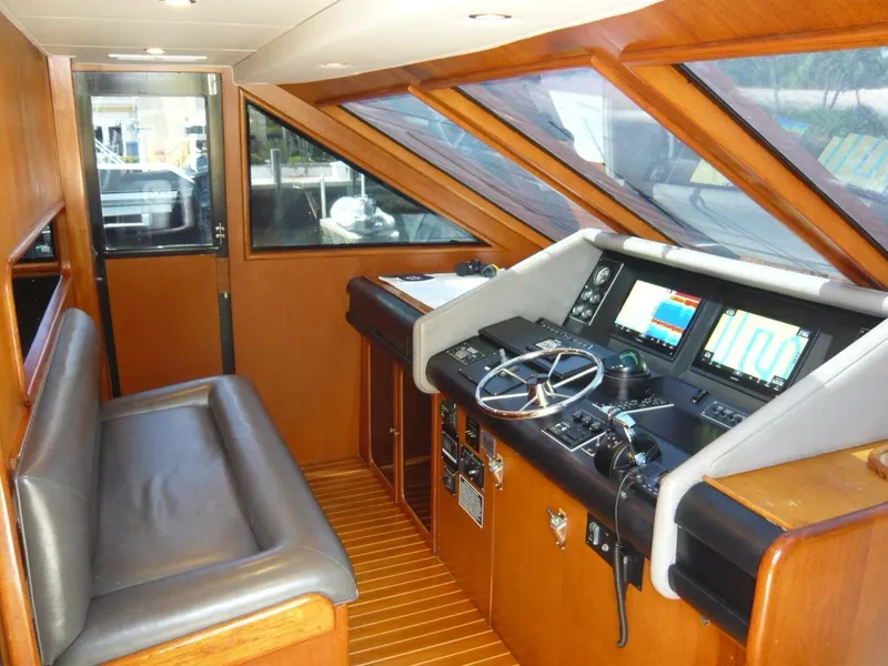 Slide: The Image of 1990 Viking Cockpit Motor Yacht interior with navigation controls and seating area. - 14