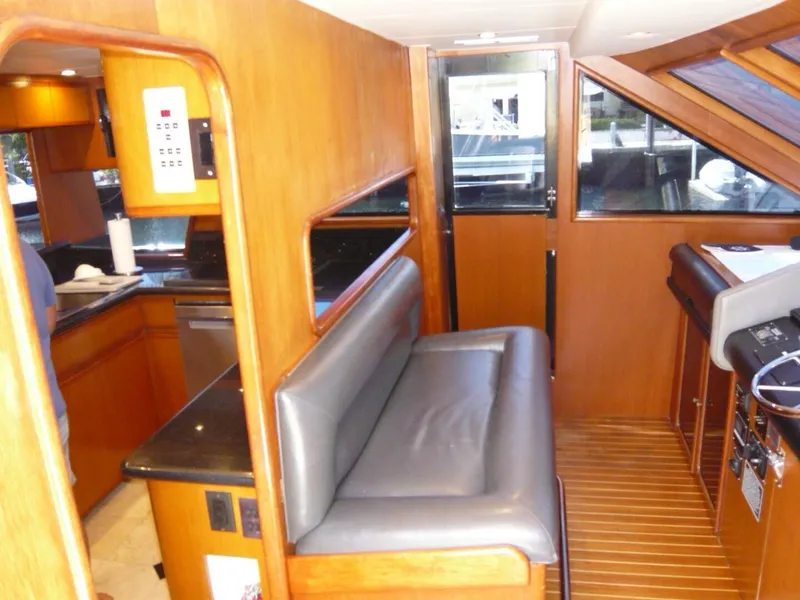 Slide: The Image of Interior of 1990 Viking Cockpit Motor Yacht with wood paneling and seating area. - 15