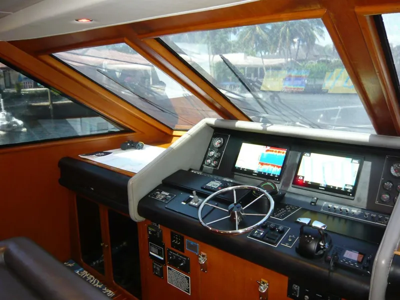 Slide: The Image of Cockpit of 1990 Viking Motor Yacht with navigation screens and steering wheel. - 16