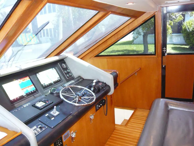 Slide: The Image of 1990 Viking Cockpit Motor Yacht interior with steering wheel and navigation controls. - 17