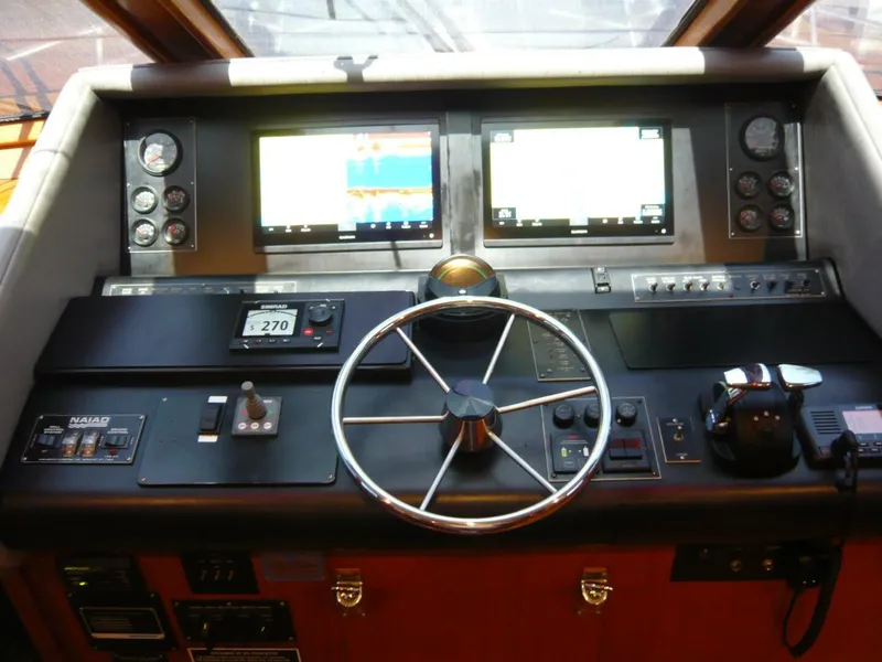 Slide: The Image of Cockpit of 1990 Viking Motor Yacht with steering wheel and navigation screens. - 19