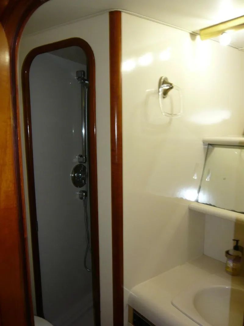 Slide: The Image of Bathroom interior of 1990 Viking Cockpit Motor Yacht with shower and sink. - 23