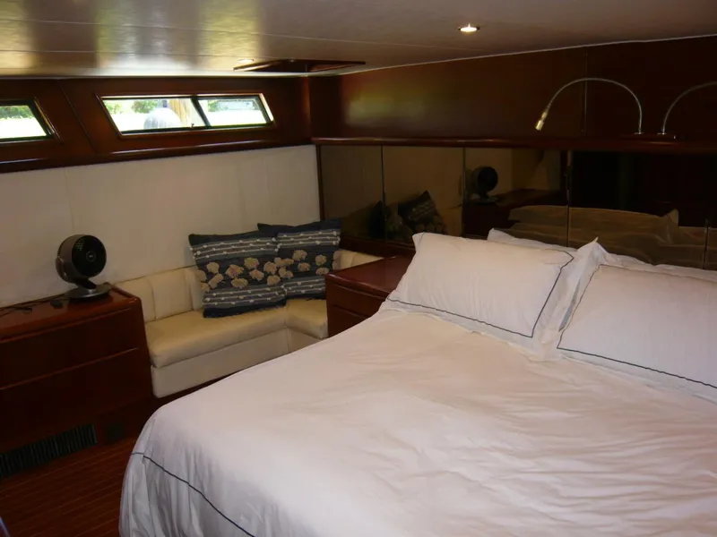 Slide: The Image of Luxurious bedroom interior of 1990 Viking Cockpit Motor Yacht with cozy bed and seating area. - 28