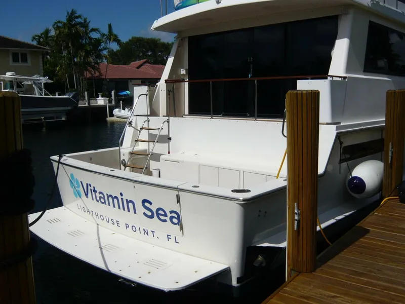 Slide: The Image of 1990 Viking Cockpit Motor Yacht docked, named "Vitamin Sea," at Lighthouse Point, FL. - 3