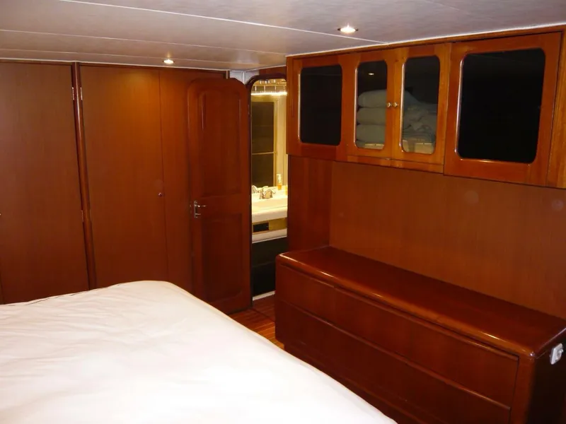Slide: The Image of Interior of 1990 Viking Cockpit Motor Yacht with wooden cabinetry and cozy bedroom. - 30