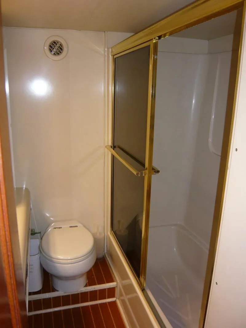 Slide: The Image of Bathroom interior of 1990 Viking Cockpit Motor Yacht with shower and toilet. - 32
