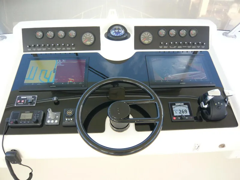 Slide: The Image of Cockpit of 1990 Viking Motor Yacht with modern navigation and control systems. - 35