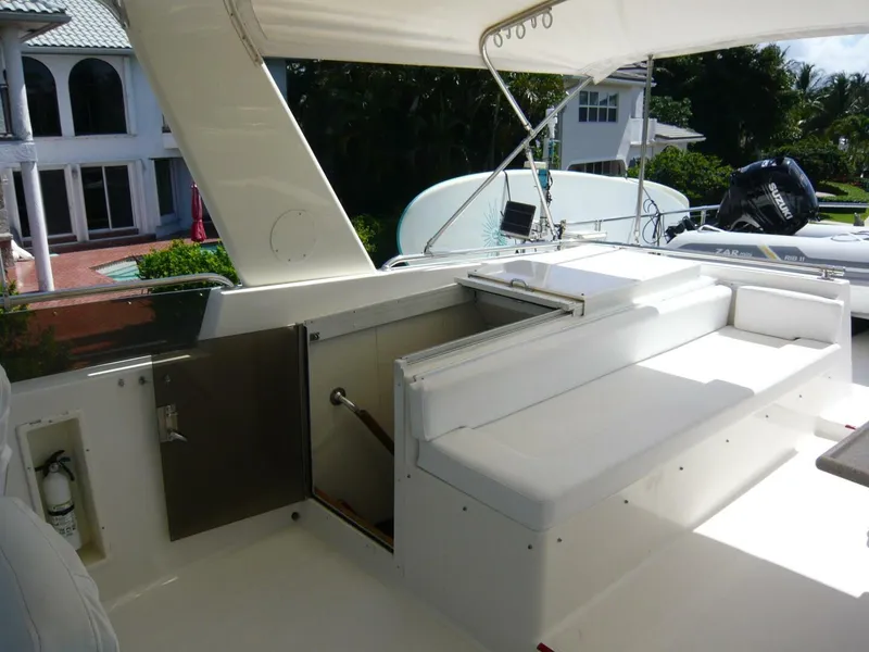 Slide: The Image of 1990 Viking Cockpit Motor Yacht interior with white seating and outdoor view. - 38