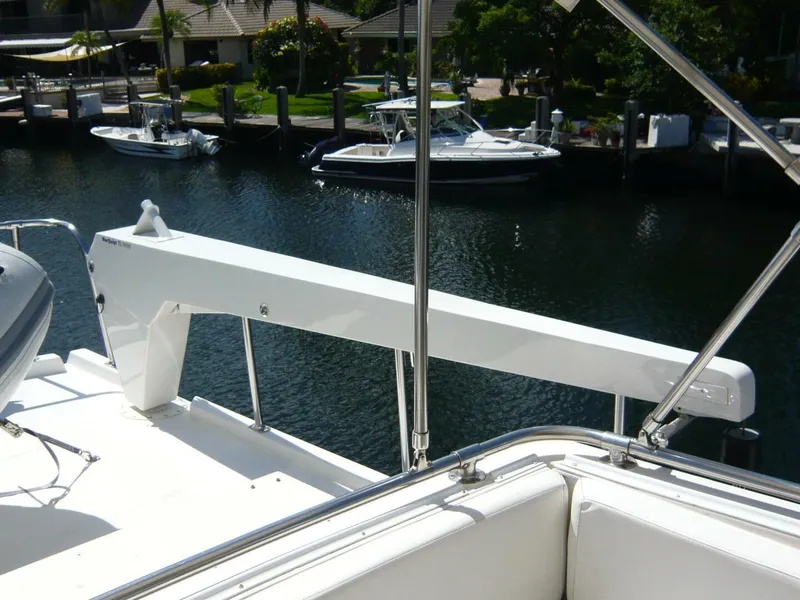 Slide: The Image of 1990 Viking Cockpit Motor Yacht deck with davit, overlooking marina with boats. - 40