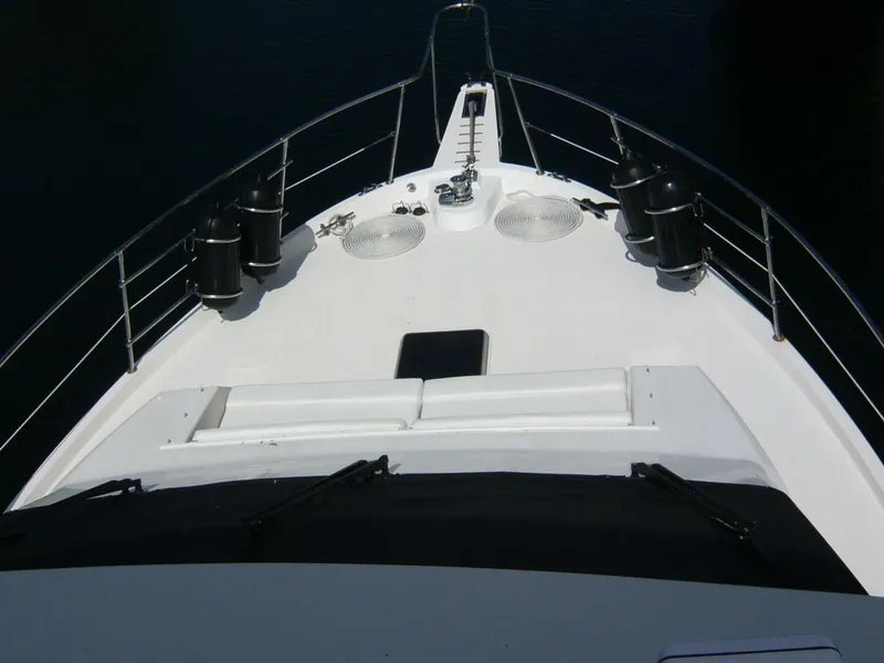 Slide: The Image of Bow view of 1990 Viking Cockpit Motor Yacht with railings and deck equipment. - 42