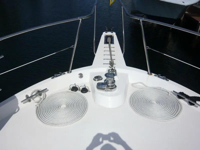 Slide: The Image of Bow of 1990 Viking Cockpit Motor Yacht with ropes and anchor equipment. - 43