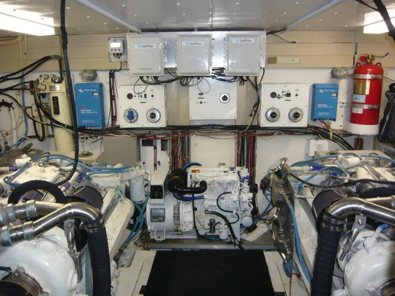 Slide: The Image of Engine room of a 1990 Viking Cockpit Motor Yacht with visible machinery and control panels. - 47
