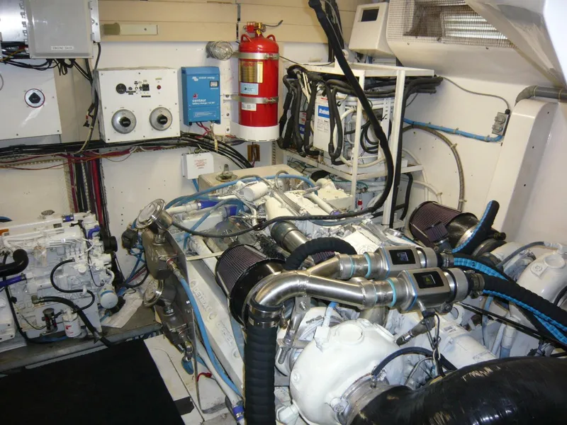 Slide: The Image of Engine room of a 1990 Viking Cockpit Motor Yacht with visible machinery and equipment. - 49
