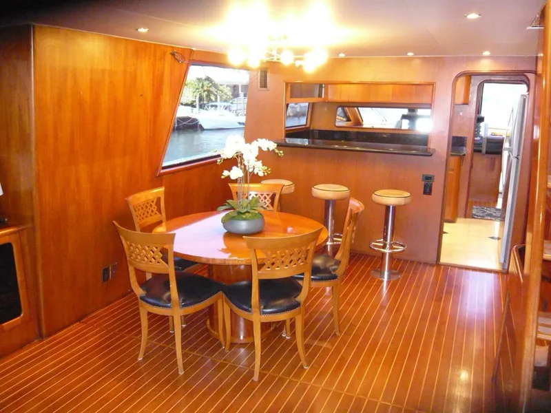 Slide: The Image of Luxurious 1990 Viking Cockpit Motor Yacht interior with elegant dining area and bar stools. - 9