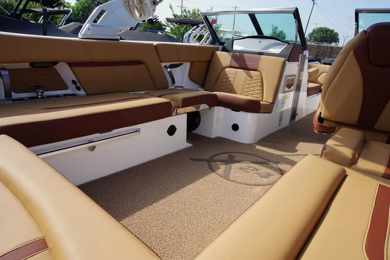 Slide: The Image of Luxurious interior of 2019 MasterCraft X24 boat with tan and brown seating. - 11
