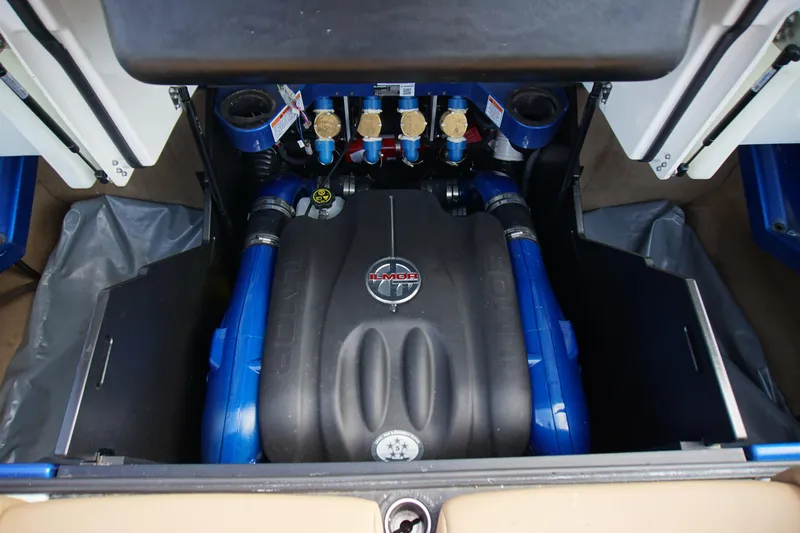 Slide: The Image of 2019 MasterCraft X24 engine compartment with Ilmor engine, showcasing blue and black components. - 13