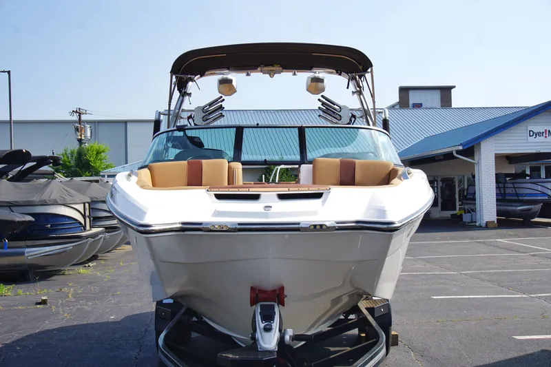 Slide: The Image of 2019 MasterCraft X24 boat displayed outdoors at a dealership. - 2