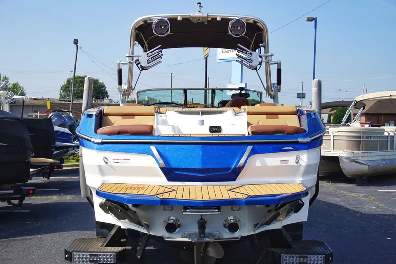 Slide: The Image of 2019 MasterCraft X24 boat with blue and white exterior, displayed in a marina setting. - 6