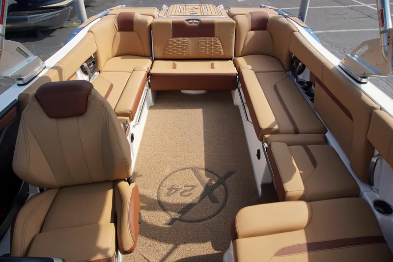 Slide: The Image of 2019 MasterCraft X24 boat interior with tan leather seating and spacious layout. - 9