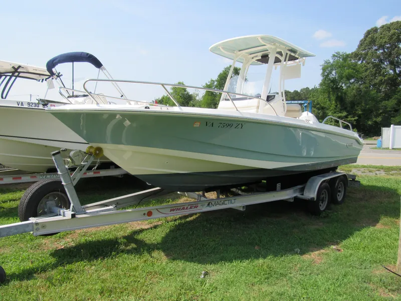 The Image of 2023 Boston Whaler 220 Dauntless boat on trailer, parked on grass. - 0