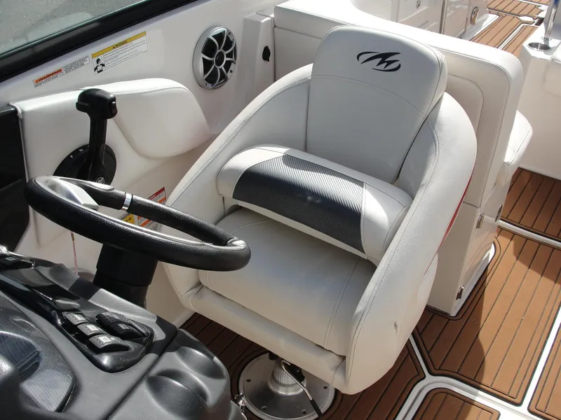 Slide: The Image of Captain's seat and steering wheel of a 2014 Monterey M5 boat, featuring sleek design and controls. - 13